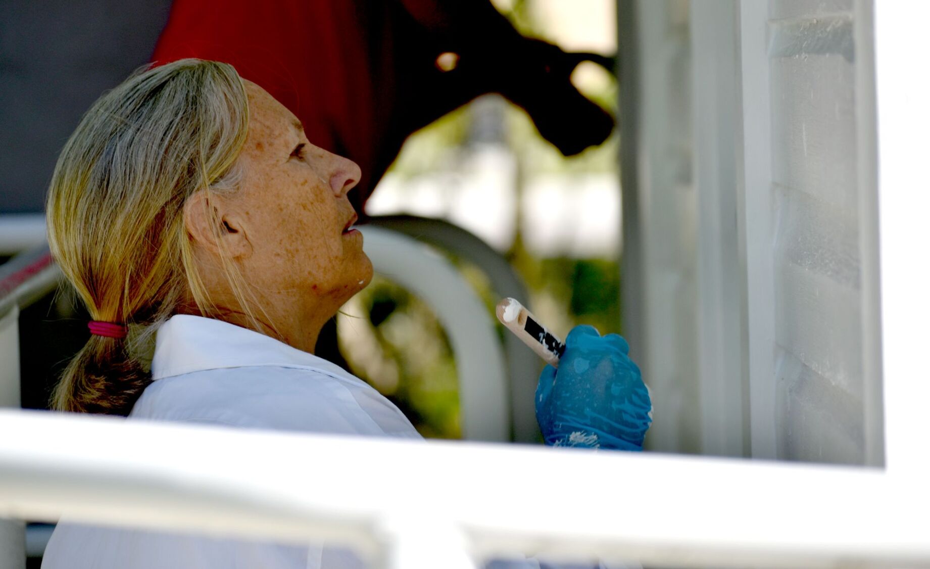 Volunteers paint historic Cigar Cottage at History Park